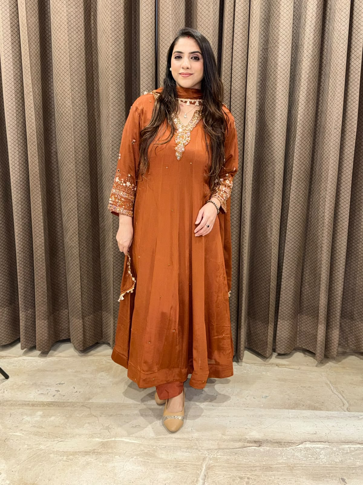 Rust designer Anarkali set with heavy handwork and dupatta