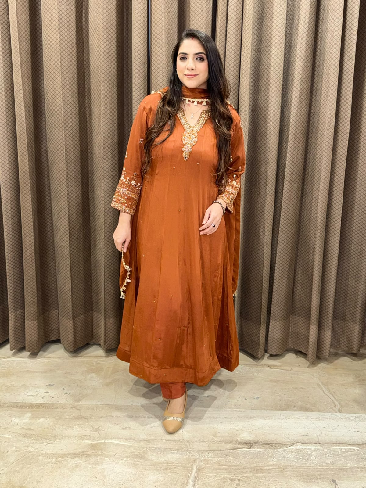 Rust designer Anarkali set with heavy handwork and dupatta