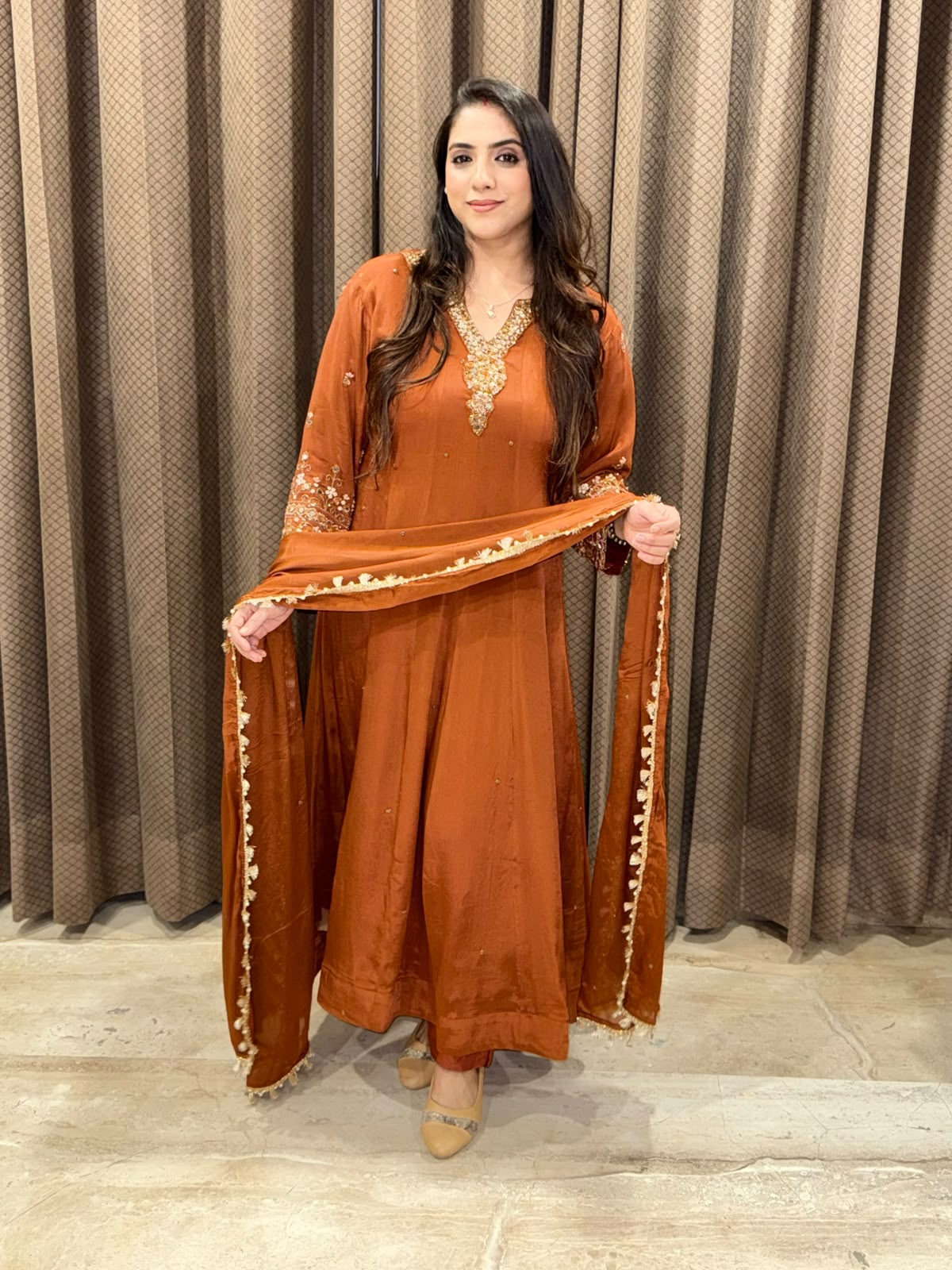 Rust designer Anarkali set with heavy handwork and dupatta